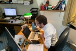 Alexander Stafford MP sits in front of his laptop to join school class on Zoom